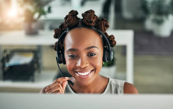 Face, call center and a happy woman with a microphone at computer for customer service or sales. Smile of a black person at a pc with a headset as telemarketing, crm support or help desk consultant.