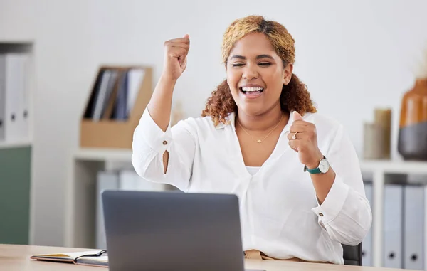 Happy, businesswoman with celebration and with laptop at her desk in a modern office workplace. Achievement or success, happiness or cheerful and celebrate female person smile for goal or target.