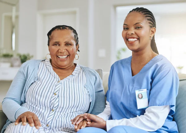 Senior woman, nurse and holding hands portrait for support, healthcare and happiness at retirement home. Elderly black person and caregiver together for trust, elderly care and help with homecare.