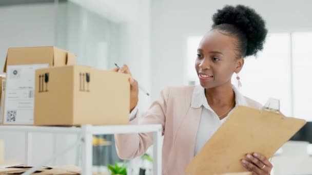 オフィスでの配達 サプライチェーンや在庫のためのクリップボード付きのボックス上の黒の女性 物流や検査 棚の上の貨物や価格製品をチェック幸せなアフリカの女性の中小企業の所有者 — ストック動画