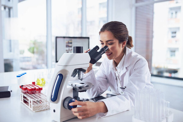 Science, research and woman with a microscope, analysis and healthcare with results, technology and experiment. Female person employee or researcher with lab equipment, career and medicine innovation.