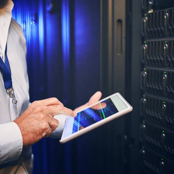 stock image Put your companys network safety in the right hands. an unrecognisable man using a digital tablet while working in a server room