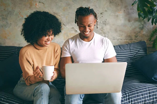 stock image Lets do a search for it. a young couple using a laptop together at home