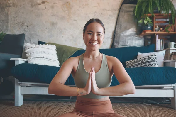 stock image If you stress less, youll suffer less. Portrait of a young woman meditating while practising yoga at home