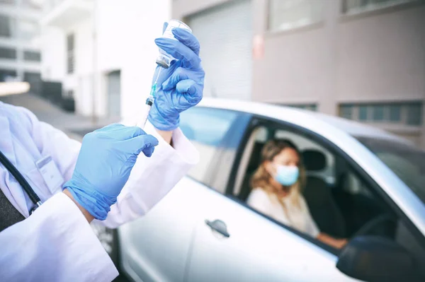 stock image Getting vaccinated is the only way forward. a doctor giving a patient an injection at a Covid-19 drive through testing centre