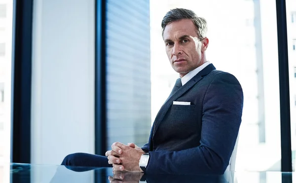 stock image I make the rules around here. portrait of a successful businessman sitting at his desk in an office