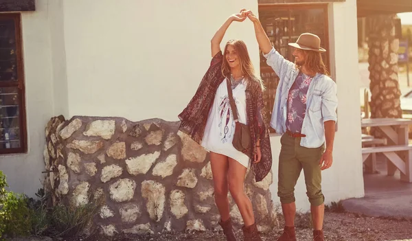 stock image Dance wherever the mood takes you. an affectionate young couple dancing outside a roadside shop