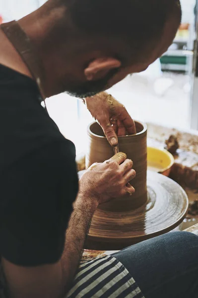 Curiosity is the key to creativity. an unrecognisable man working with clay in a pottery studio