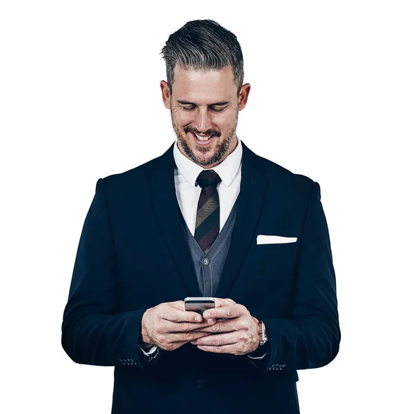 Stock image Downloading apps that support his executive needs. Studio shot of a businessman using a mobile phone against a white background