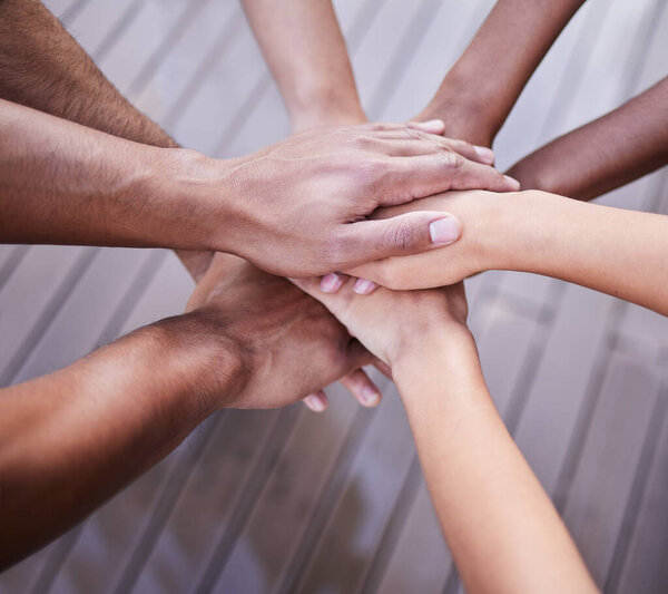 Teamwork, hands and diversity of people in support, agreement and circle of trust for motivation. Closeup, community and helping hand of group, equality and celebration of success, mission or synergy.