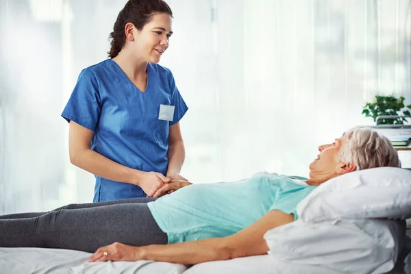 stock image Let me know if theres anything you need. a young female carer assisting her senior patient in the hospital