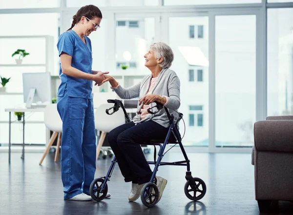 Im here to help you. Full length shot of a young female nurse talking to her senior patient in the old age home
