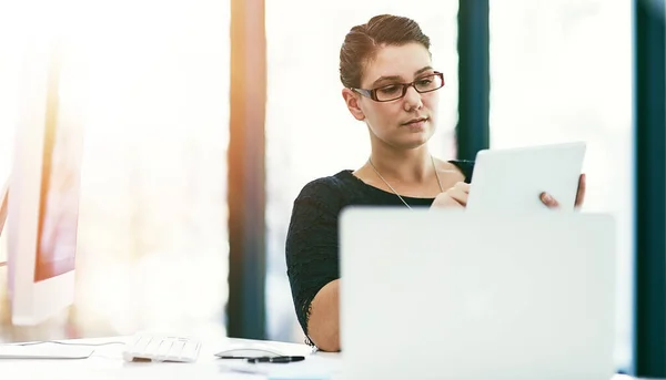 stock image The right tools can drive efficiency into your performance. a young businesswoman working at her desk in an office