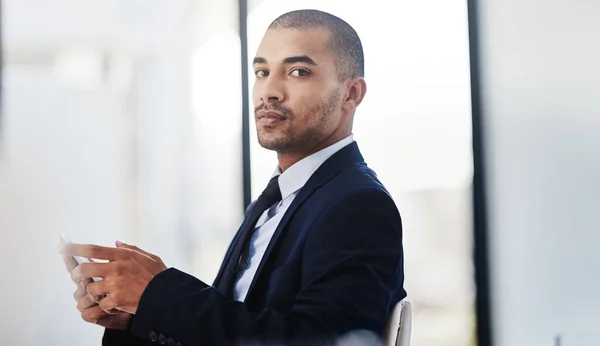 stock image An endless supply of information is always close at hand. a young businessman using a digital tablet at work