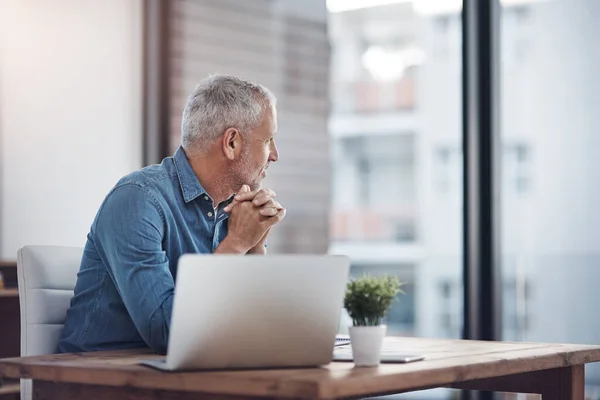 Stock image One thing he never falls short of is innovative ideas. a thoughtful mature businessman working at his office desk