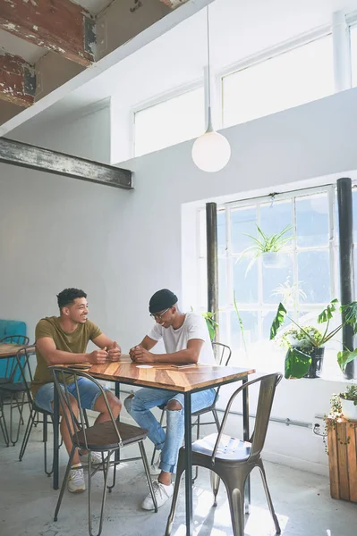 stock image Were brothers more than friends. Full length shot of two handsome friends sitting together and bonding in a coffeeshop during the day