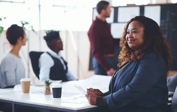 stock image Shes ready to soar beyond her dreams. a young businesswoman using a digital tablet during a meeting in an office