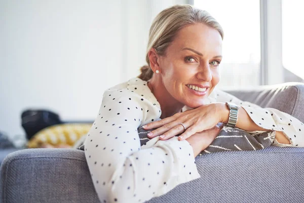 stock image Couch time is my favorite time. a happy mature woman relaxing on the sofa at home