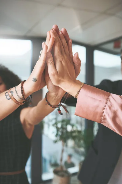 stock image Weve got the winning idea. an unrecognizable group of businesspeople standing together and giving each other a high five in the office