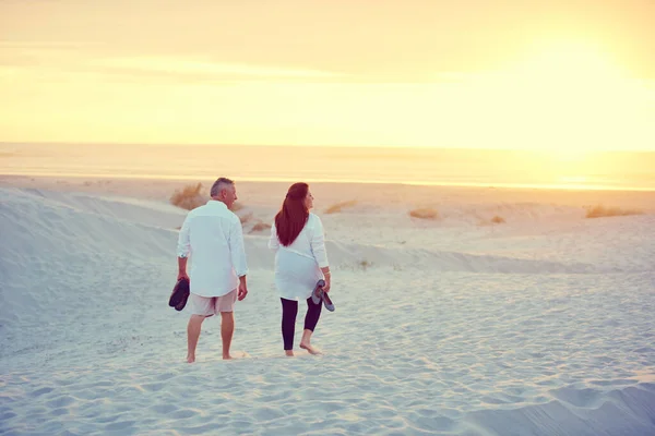 让我们来看看哪里是免费的 一对成熟的夫妇在海滩上悠闲地散步 — 图库照片
