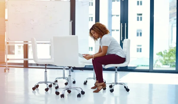 stock image The ideal tool to promote creativity. a young businesswoman using a digital tablet in a modern office