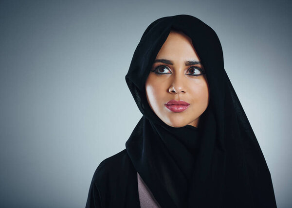 Thought determines outcome. Studio shot of a young muslim businesswoman against a grey background