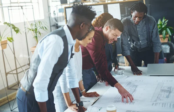 stock image Keep in mind what the client wants. a team of professionals working on blueprints in an office