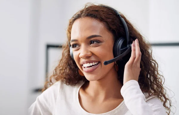 Call center, working and face of woman in customer service office, crm or telemarketing support, help or consulting worker. Contact us, helping consultant and advice in communication or conversation.