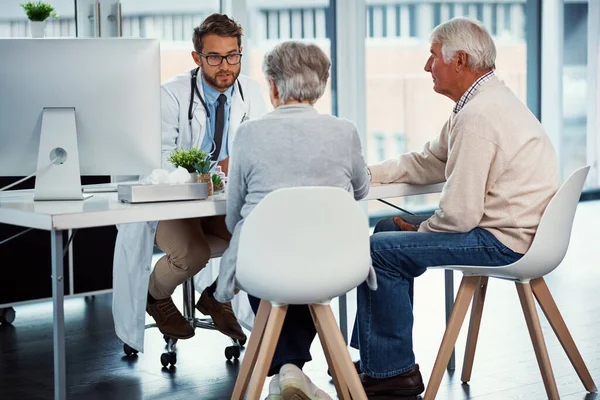 stock image Patients appreciate his expert and honest advice. a doctor having a consultation with a senior couple in a clinic