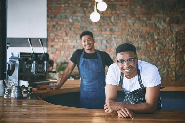 stock image Happiness begins with brew. two confident young men working in a cafe