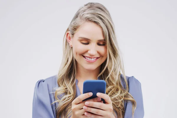 stock image Smartphone, typing and woman in studio with smile for social media, internet and online chat. Communication, white background and happy female person on cellphone for website, mobile app and texting.