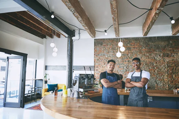 stock image Behind great coffee is a great barista. two confident young men working in a cafe