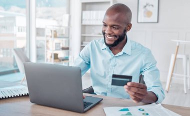 Kredi kartı, çevrimiçi alışveriş ve siyahi adam bir ofiste ekommerce alımı için dizüstü, internet veya internet kullanır. İş adamı, Afrikalı ve çalışanın şirket ofisindeki bir web sitesinde ödeme yapması.