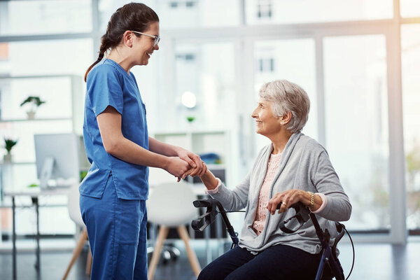 Im glad youre happy here. a young female nurse talking to her senior patient in the old age home