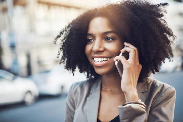 stock image Happy woman, phone call and communication in city for conversation or networking outdoors. African female person talking on mobile smartphone with smile for fun discussion in street of an urban town.