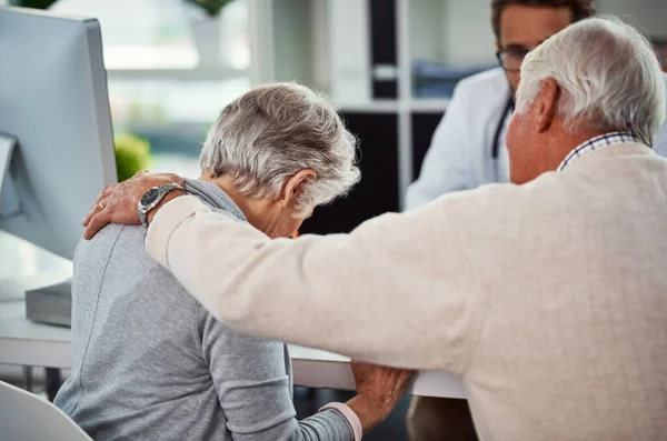 stock image She just cant deal with all the complications. a senior man consoling his wife during a consultation with a doctor in a clinic