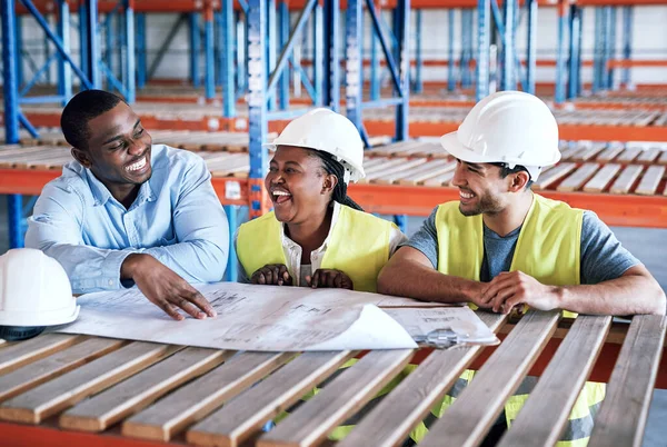 Business people, architect and blueprint laughing in construction, planning or funny team building on site. Happy contractor in teamwork, laugh or project plan in fun industrial architecture together.