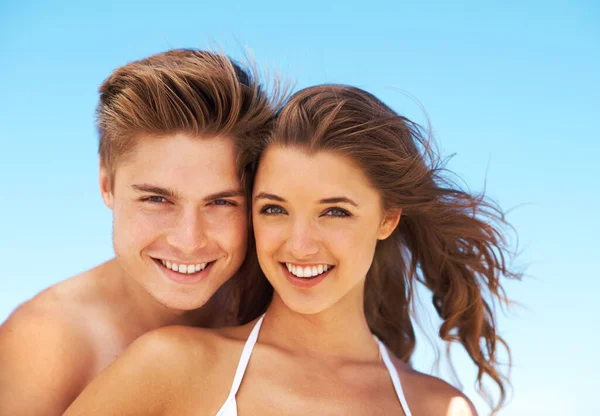 stock image This is our first summer together. Cropped portrait of an affectionate young couple standing together at the beach during the day