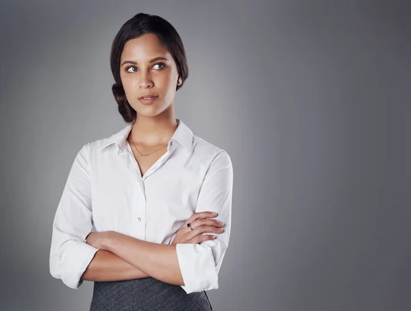 stock image Firmly fixed on achieving her career goals. Studio shot of a young businesswoman posing against a gray background