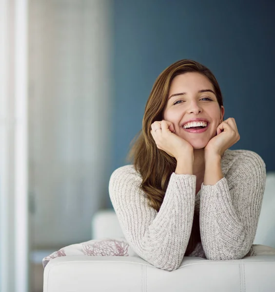 Stock image Portrait, funny and woman relax on sofa in home living room laughing at comedy. Face, excited or happy female person from Canada on couch in lounge, apartment or house to enjoy me time, joke or humor.