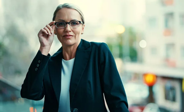 stock image Success. Ive always had it in my sights. Portrait of a mature businesswoman standing outside on the balcony of her corporate office