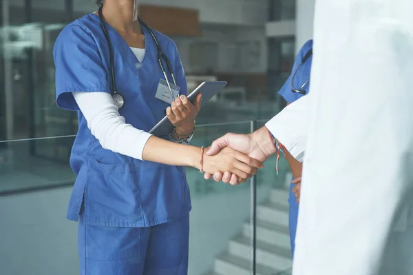 stock image This is the perfect role for you. an unrecognizable nurse standing and shaking a doctors hand in the clinic