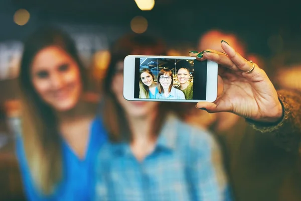 stock image These are the memories well hold for life. three young friends taking a selfie together in a cafe