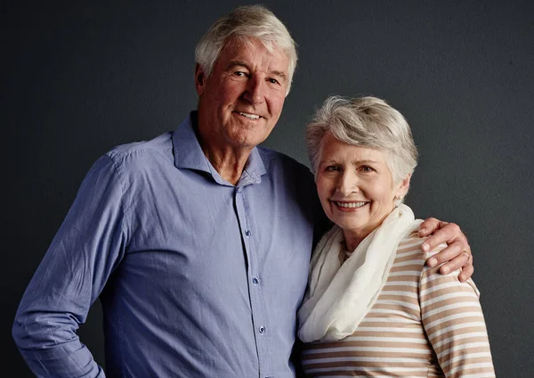 stock image Together forever. Studio portrait of an affectionate senior couple posing against a grey background