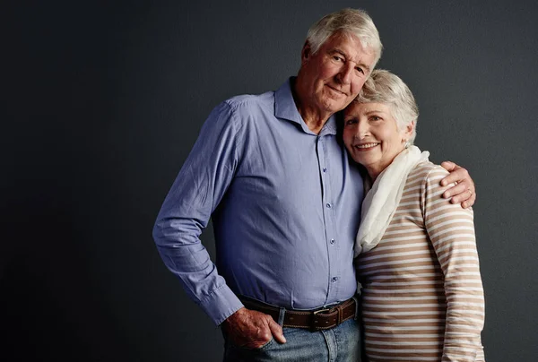 stock image Hes my one true love. Studio portrait of an affectionate senior couple posing against a grey background