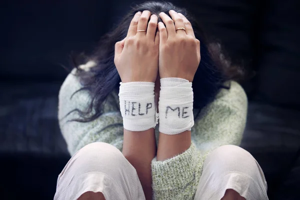 Wrist, depression and woman with help on bandage for suicide, self harm or person in dark mental health crisis. Bandages, girl and injury from depressed accident, problem or mistake in cutting wrists.