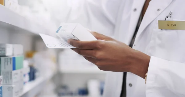 stock image Ill need one more of these. Closeup shot of an unrecognizable young pharmacist filling a prescription in a chemist