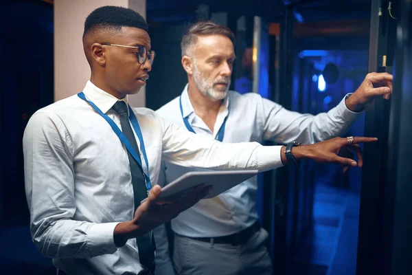 stock image The solution is what theyre working on. two technicians using a digital tablet while working in a server room