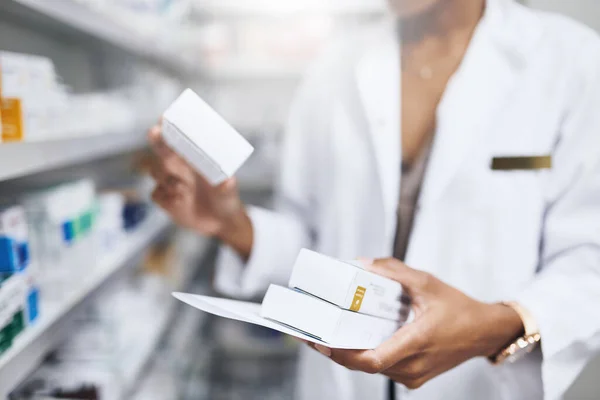 stock image Get your prescriptions filled here. a pharmacist filling a prescription at a chemist