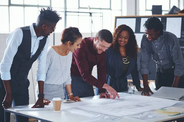 stock image This is exactly what the client asked for. a team of professionals working on blueprints in an office